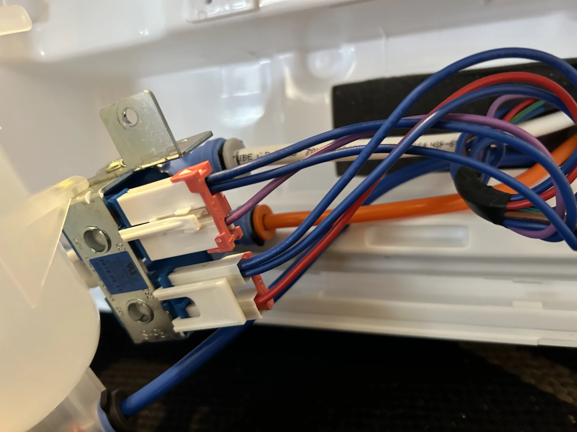 Close-up of water valves and tubing transferred to new LG refrigerator door