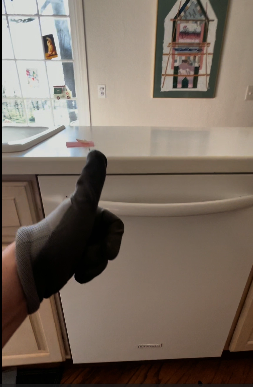 Technician from TI Constant Inc. installing new heater in KitchenAid dishwasher